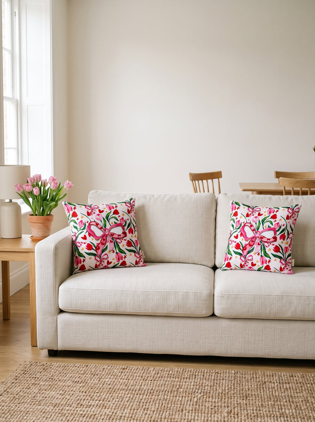 Fiora Bow & Floral set of 2 cushion covers – two cushions on a sofa