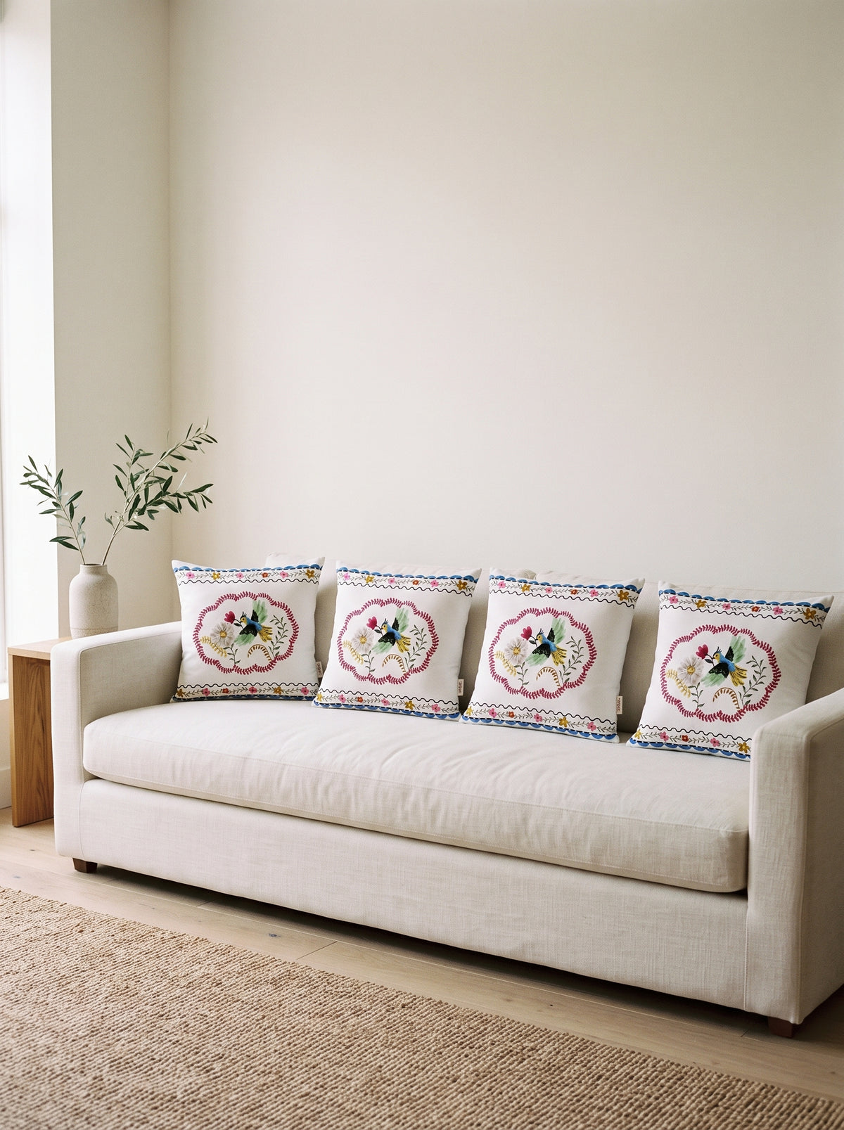 Mila Bird & Floral set of 4 cushion covers – four cushions on a sofa